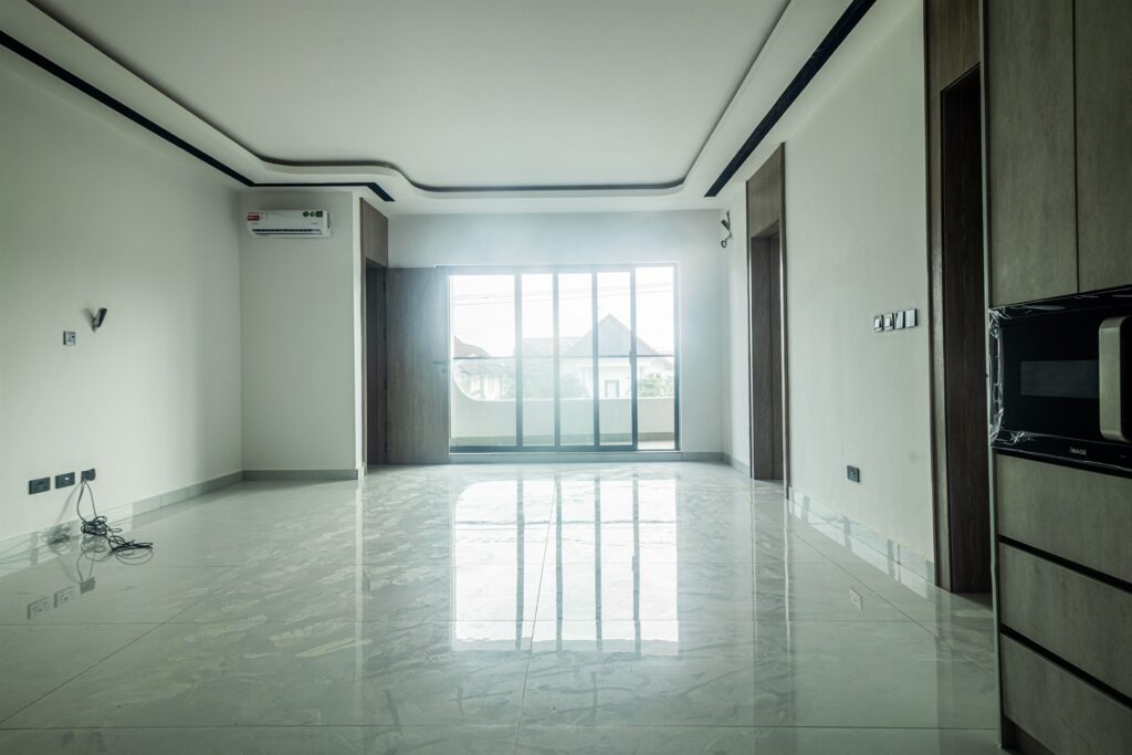 Brum Height 8: Unfurnished living room opening onto a balcony